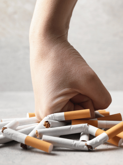 Cigarettes being crushed by a fist